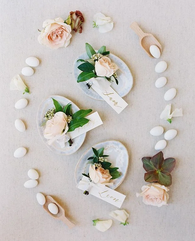Sneak peak film photos from @carliestatsky speak our love language ✨ bringing little props to style is one of our favorite details of the day 👏🏼 sugared almonds as a nod to our couples Greek heritage, and the most perfect bouts from @gavitaflora #f