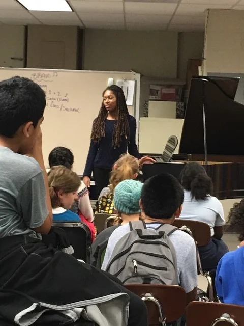 Isata speaks and plays at Cesar Chavez School.