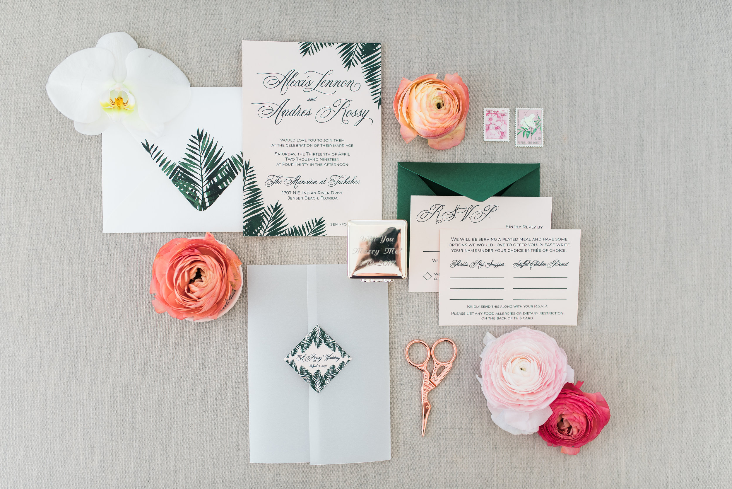 tropical Invitation Suite with palm tree leaf details printed on shimmer blush stock. vellum gatefold with wedding info icon on the front. Double RSVP with Forest Green envelope. Photo shot by Aurora Photography