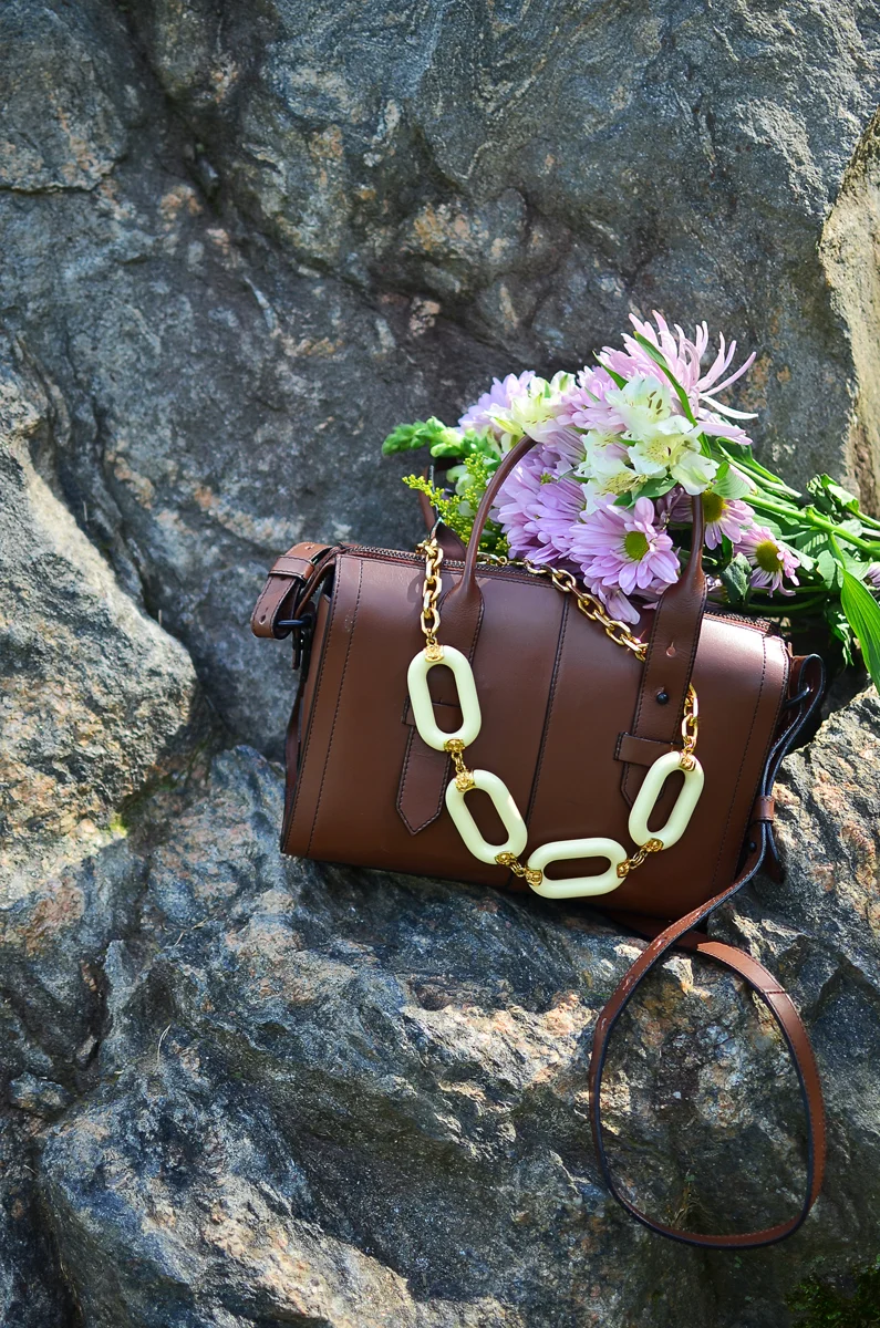 Kenneth Jay Lane resin chain link necklace in ivory and gold with iiibeca broadway satchel.
