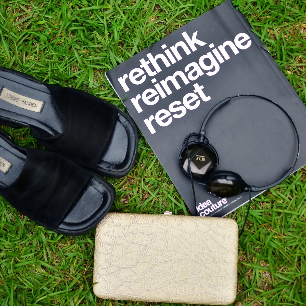 Top down shot of Steve Madden slides and TJ Maxx clutch.
