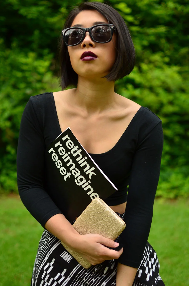 Me wearing groceries apparel's 3/4 sleeve black crop top with dolce vita geometric skirt.