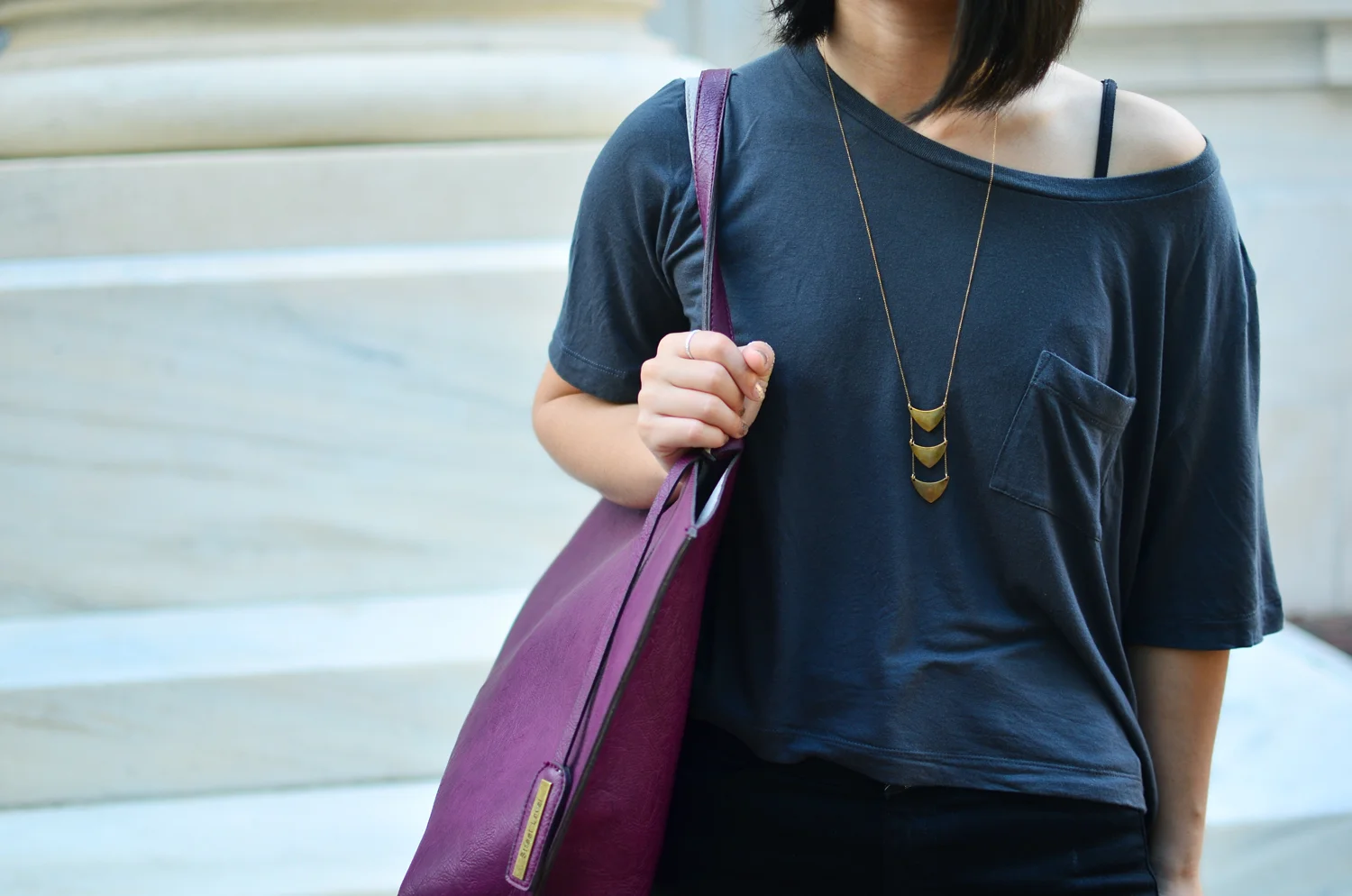 Closeup of Crafts and Love necklace and Gap slub tee.
