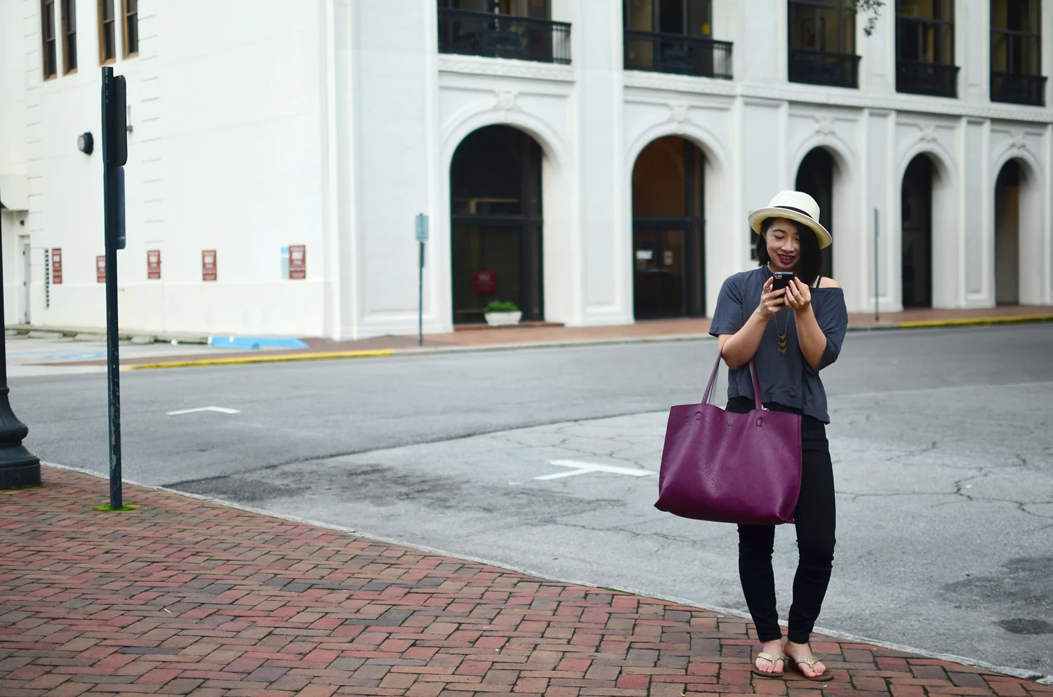 Aritzia fedora hat with Gap slub gray tee, Closed Denim skinny pusher jeans, and Olukai Kumu sandals.