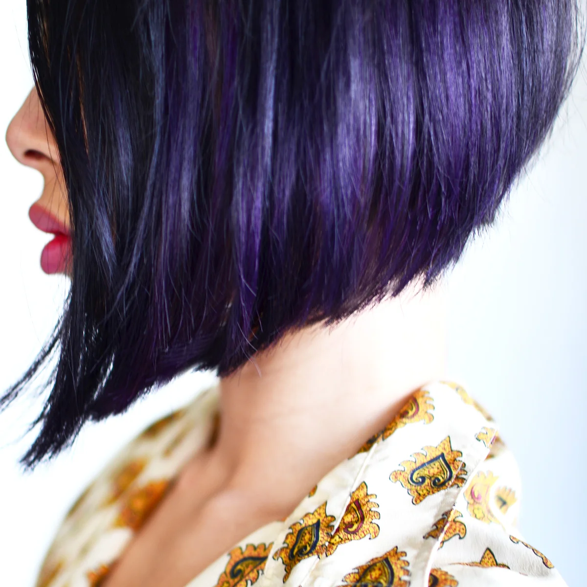 Purple hair highlights on an angled bob.