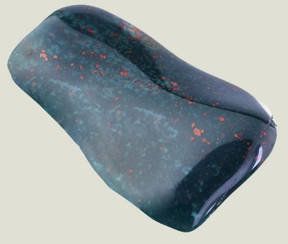 A colorful granite desk organizer or container with a mix of blue, black, and red speckles.