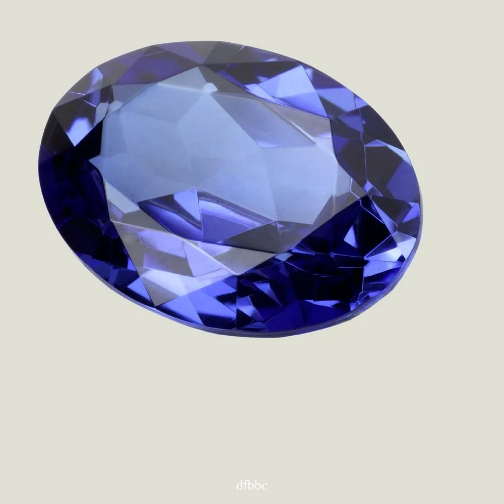 A large, oval-cut blue gemstone with facets reflecting light.