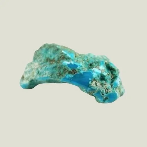A small, irregularly shaped mineral or gemstone with blue, green, and brown hues.