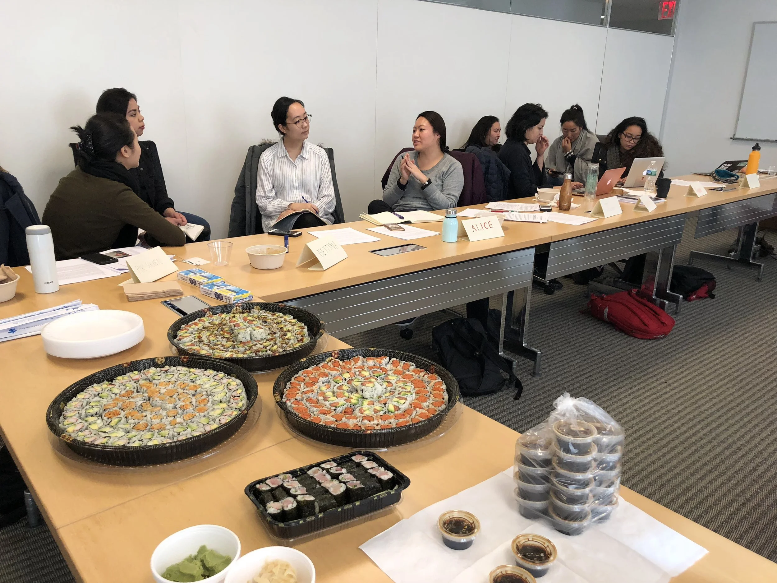 Sushi arrives while everyone breaks into groups to discuss each other’s works.