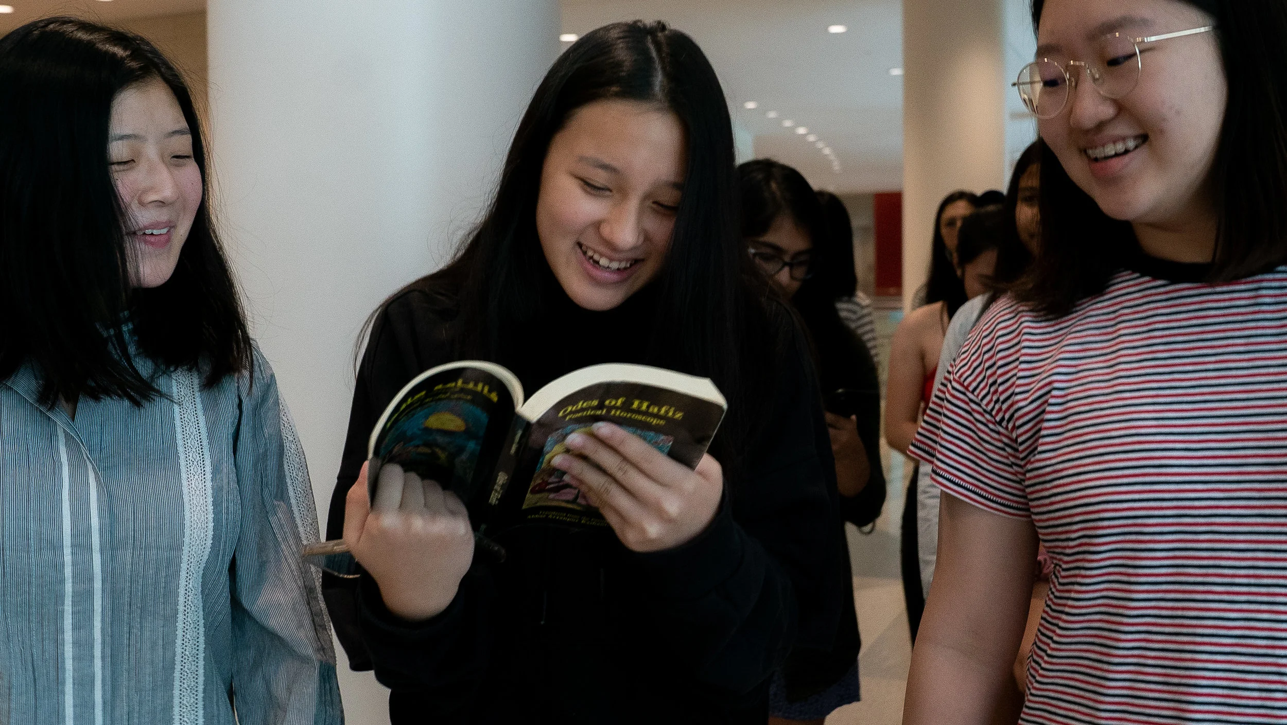 Sarah Huang, Emily Wang, and Erin Choi seek guidance in the Odes of Hafiz ! Photo by Zoraida Ingles.