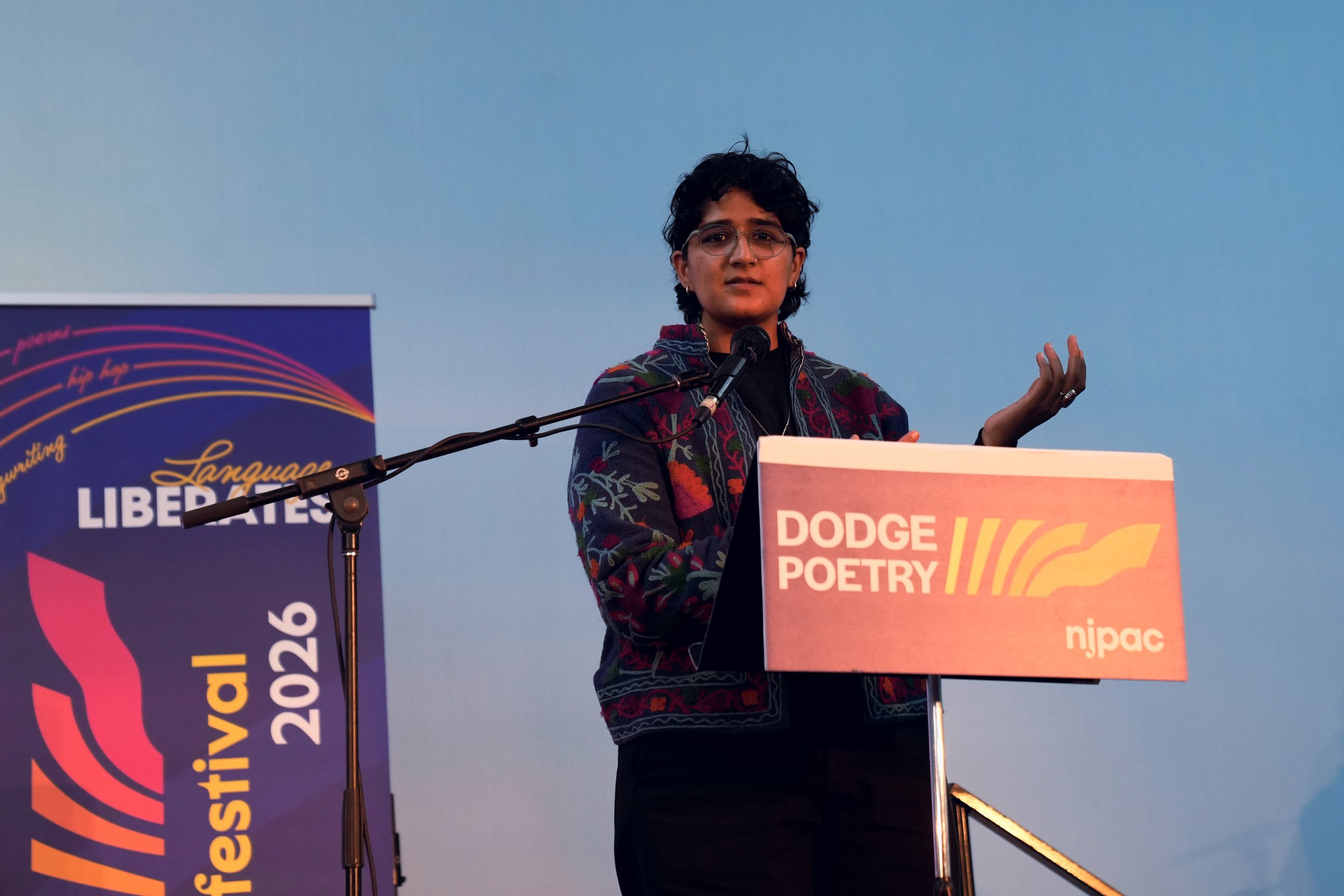 A writer reads from behind a podium.