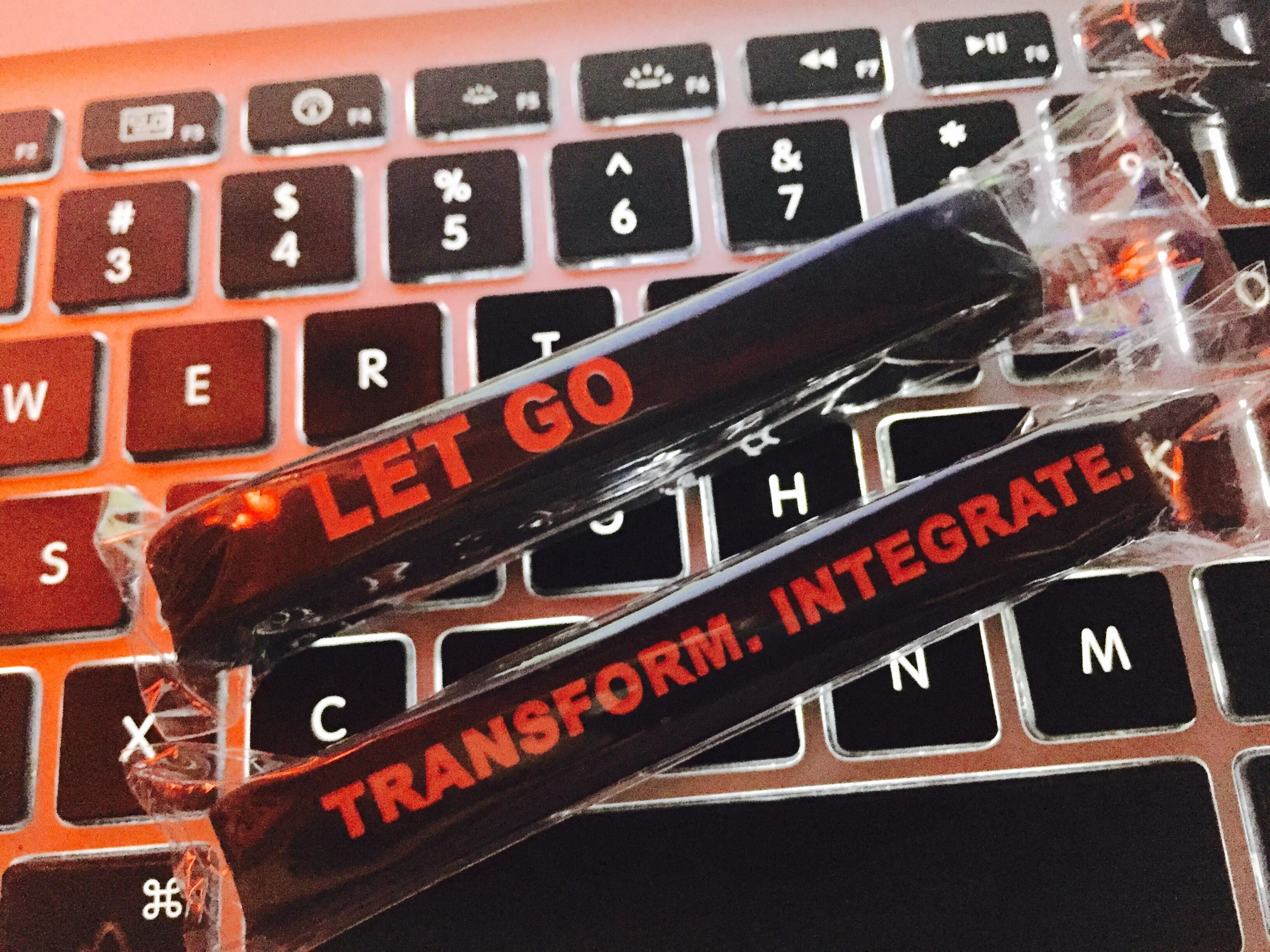 One side says LET GO. Other side says TRANSFORM. INTEGRATE. I inspected it and they are very high quality. 