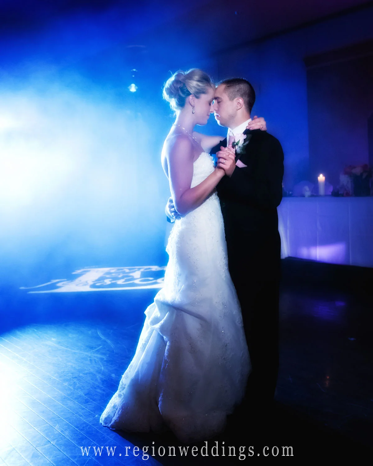 A bride and groom dances their first dance at Avalon Manor in Merrillville as a beautiful blue hue of color engulfs them.