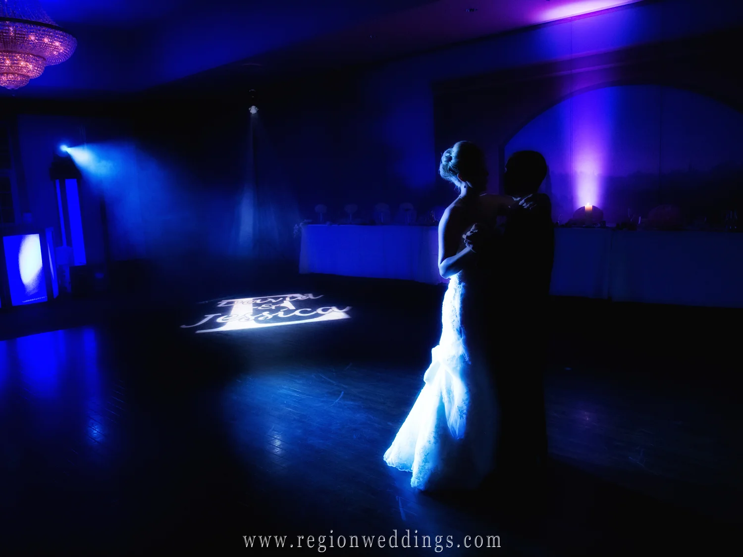 A couple dances alone in the dark at Avalon Manor in Hobart, Indiana for their Fall wedding reception.