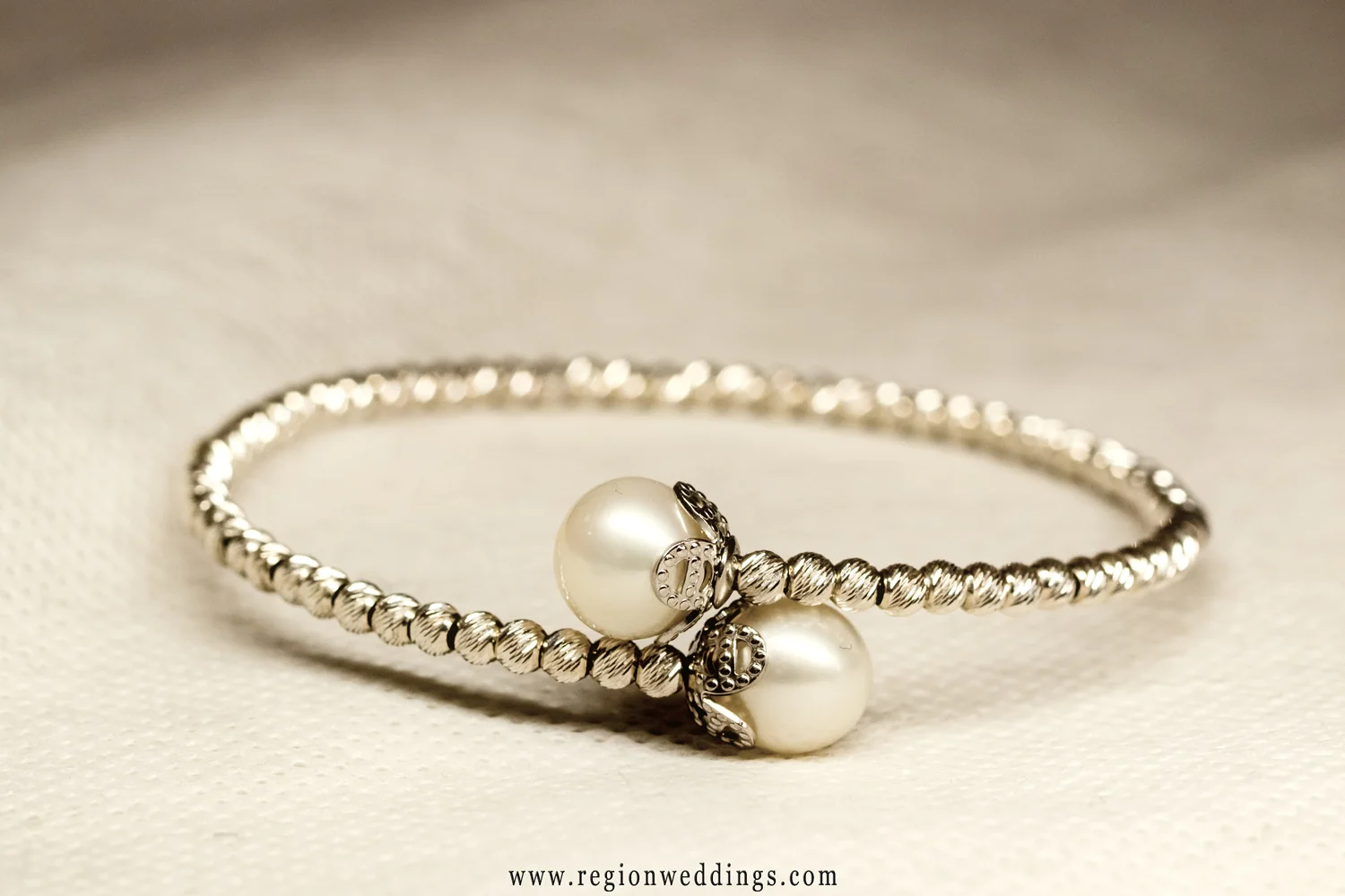 The bride's bracelet shown in a sepia toned wedding photo.