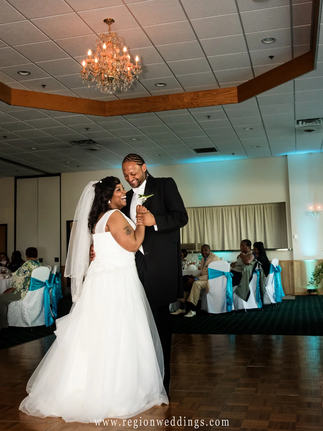 The bride and groom laugh it up during their first dance at an afternoon wedding reception at The Patrician.