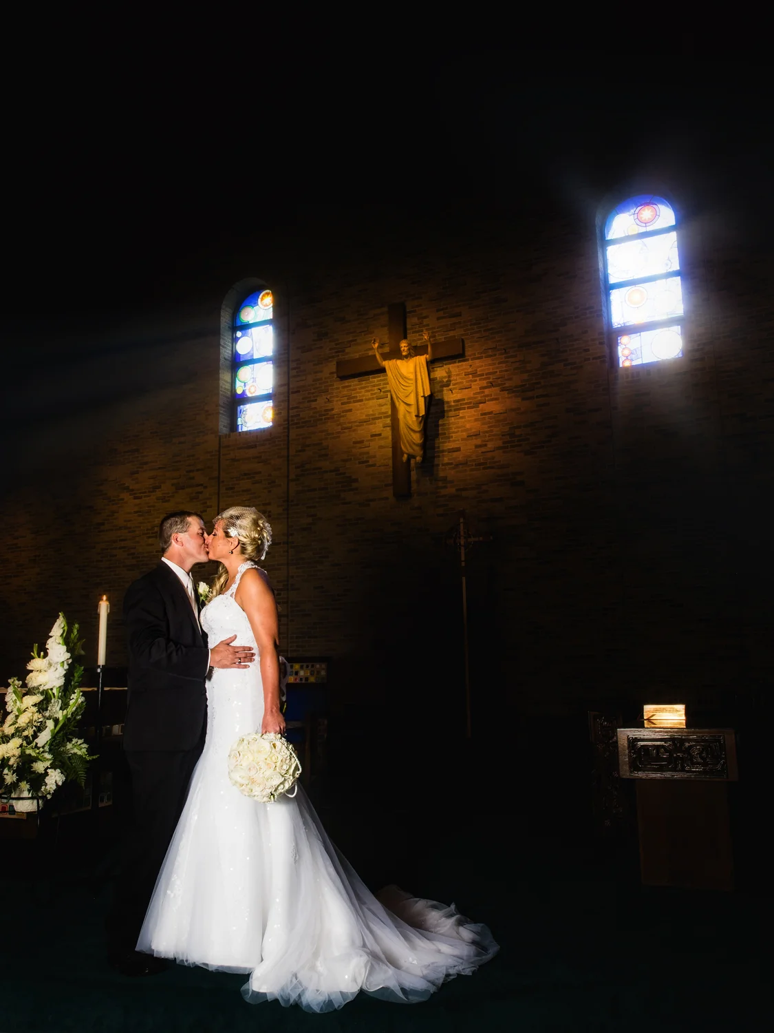 Bride and groom kiss on the altar.