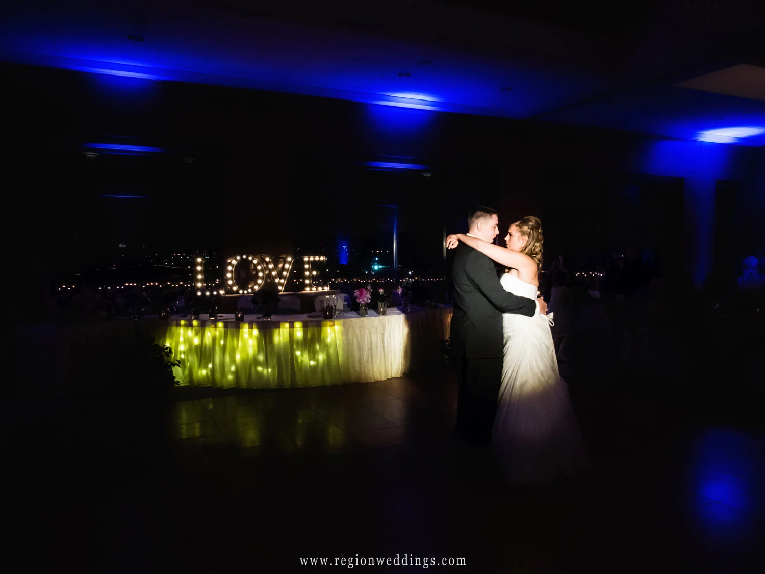 The first dance in front of an illuminated sign of LOVE at Centennial Park.