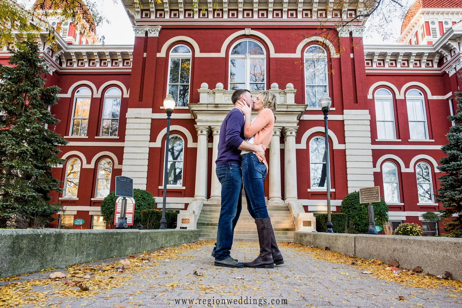 A couple in love kiss romantically at the steps of the Old Crown Point Courthouse.