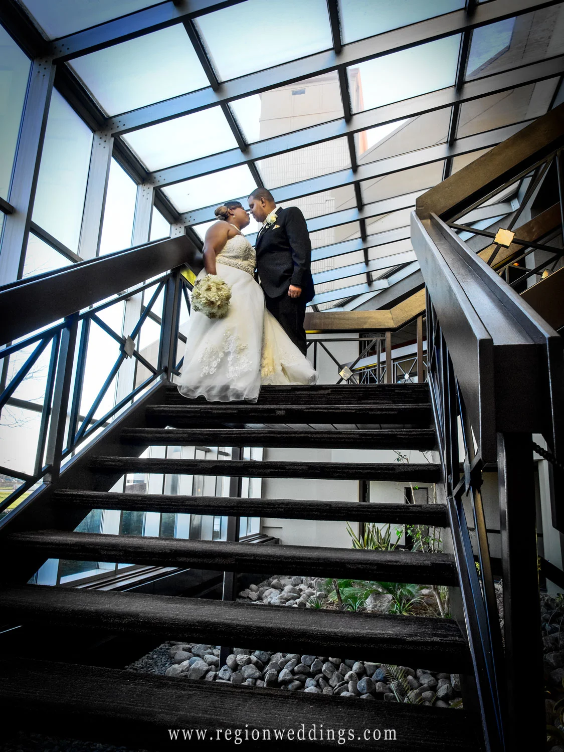 Bride and Groom on the staircase at Radisson at Star Plaza Theater.