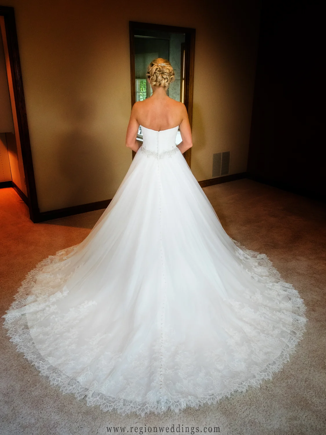 The bride shows off the back of her dress.