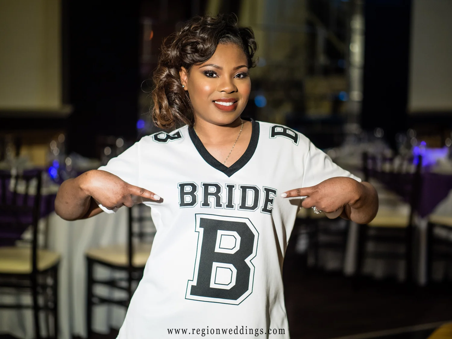 The bride shows off her "bride jersey" inside The Allure ballroom.