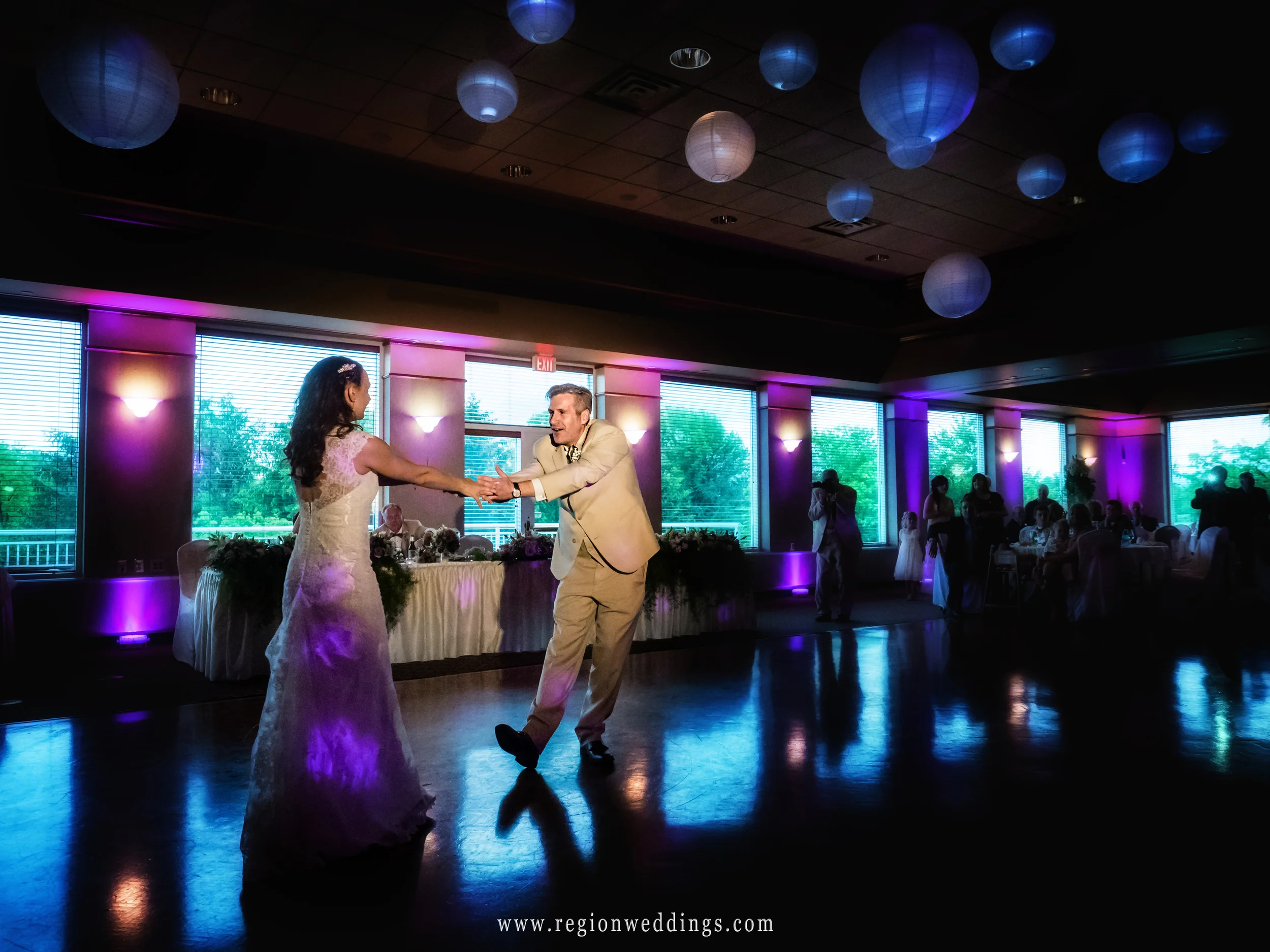 Colored sky balloons overlook the bride and groom's first dance.