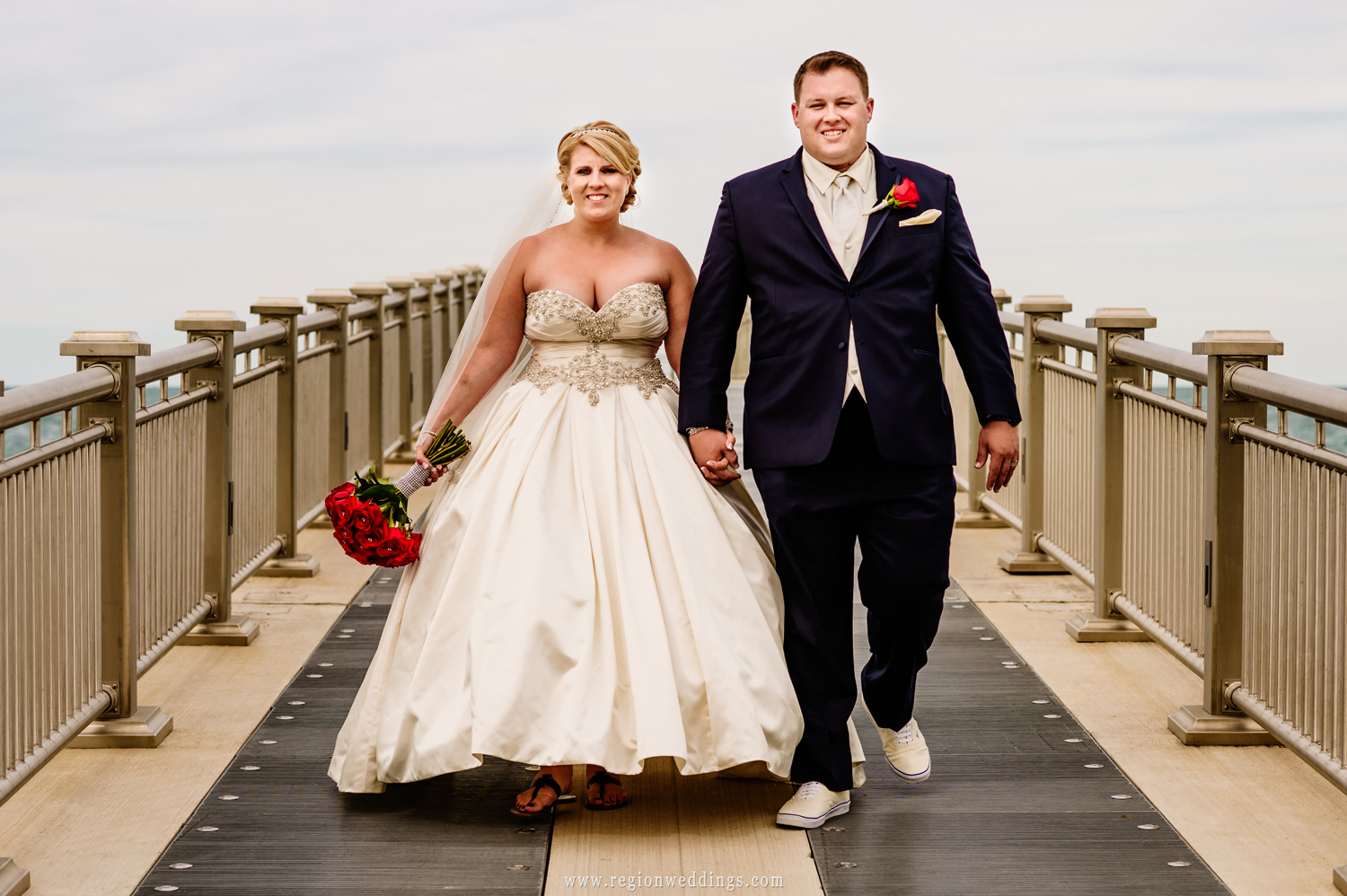 The bride and groom take a walk along the pier at Whiting Lakefront Park.