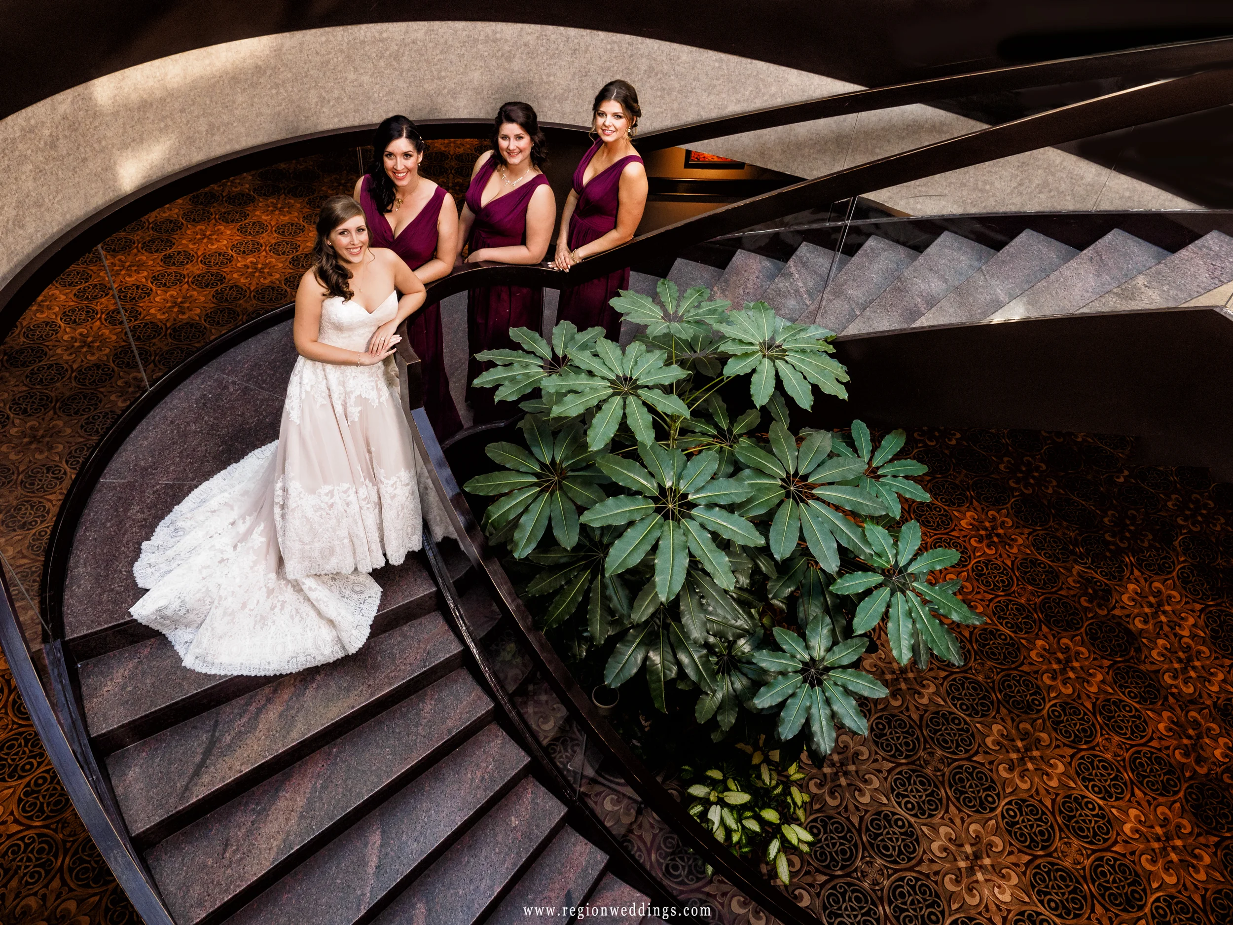 Bride and her bridesmaids on the staircase at The Center for Visual and Performing Arts.