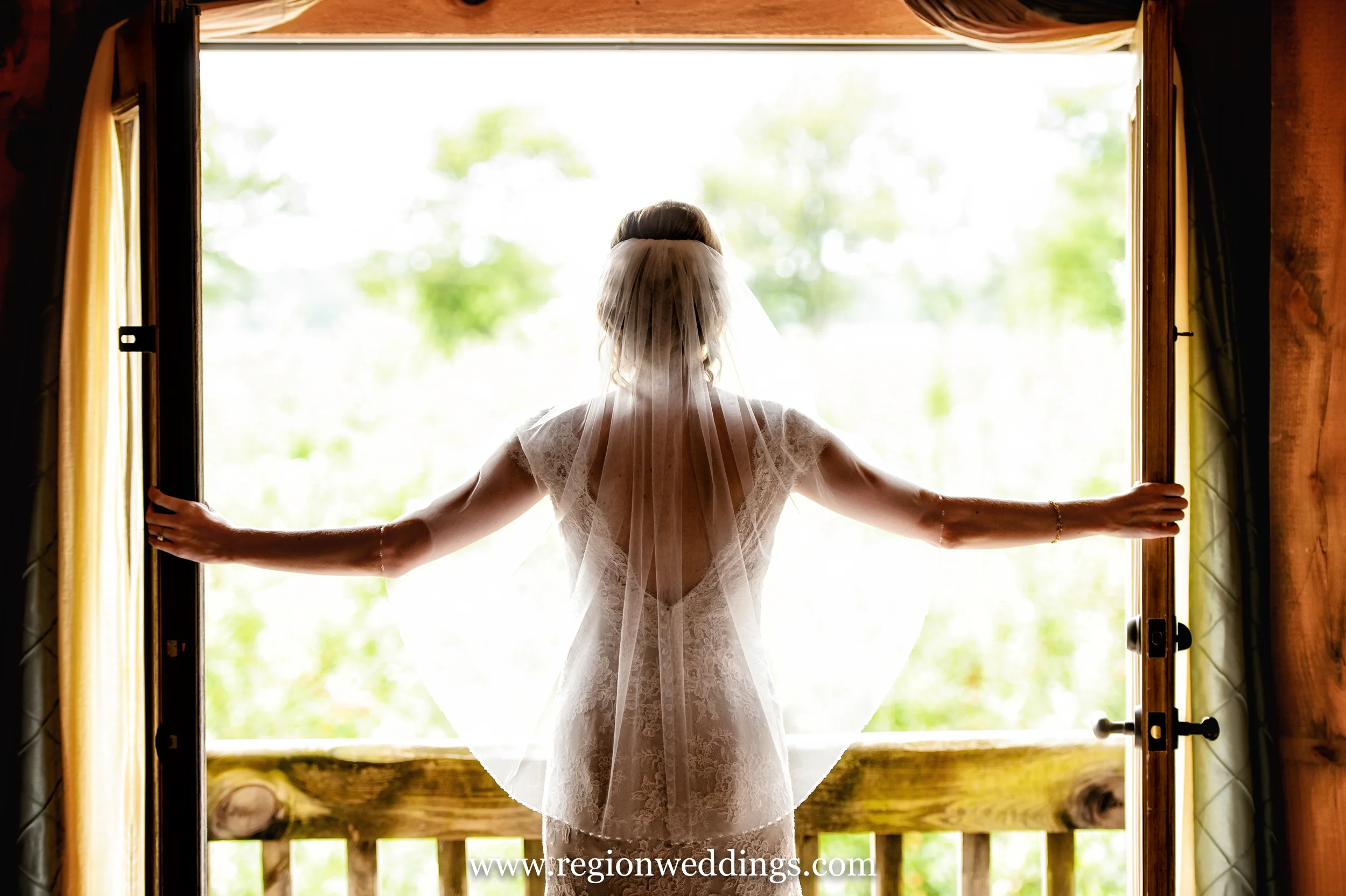 The bride opens the balcony door at County Line Orchard.