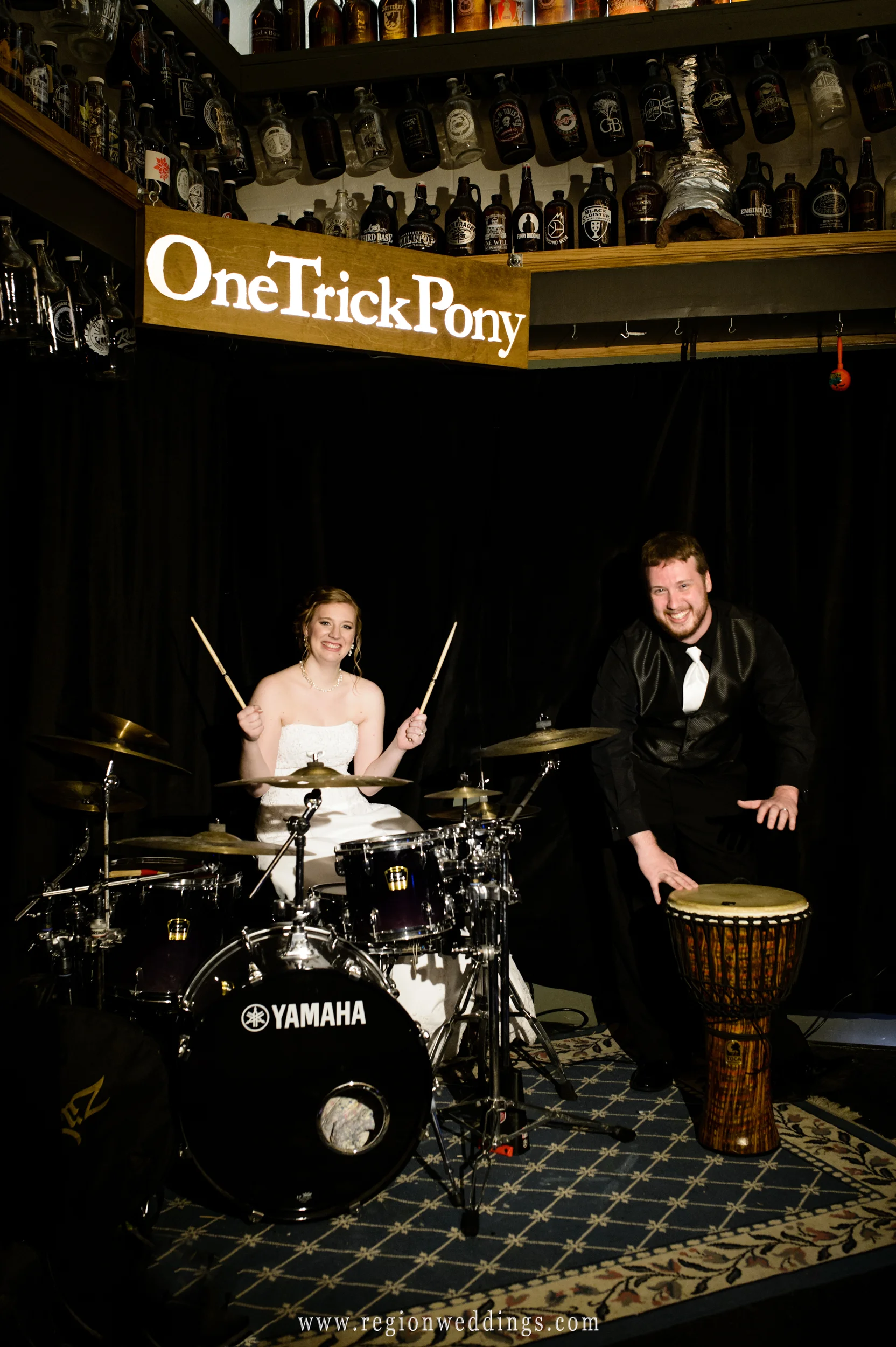 Bride and groom behind the drum kit at One Trick Pony brewery.