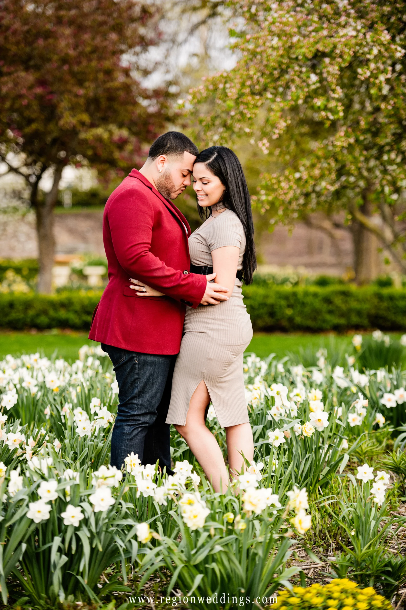 Engagement photo in a bed of flowers in Valparaiso, Indiana.
