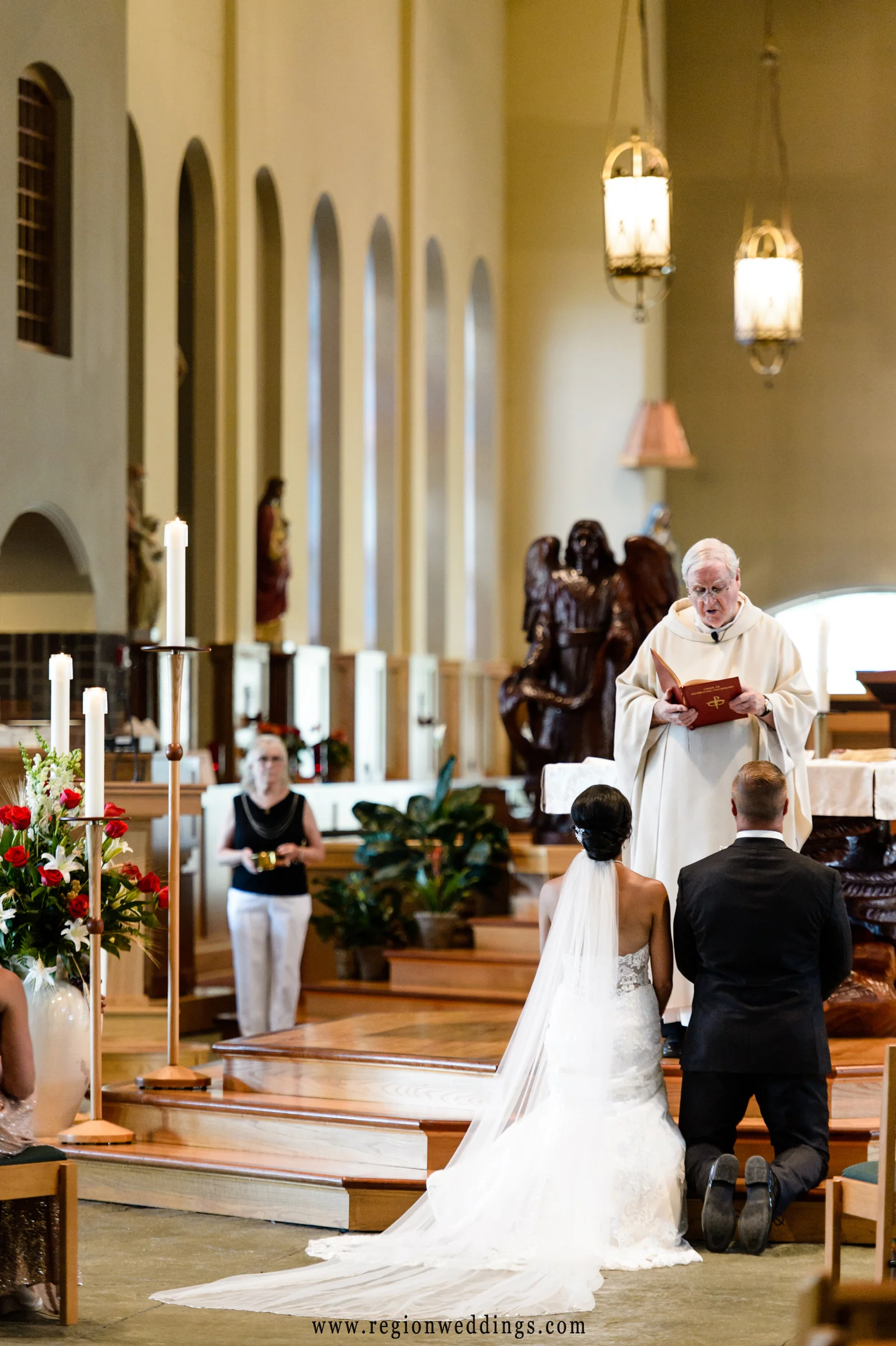 Bride and groom listen to Father during mass of their Catholic wedding.