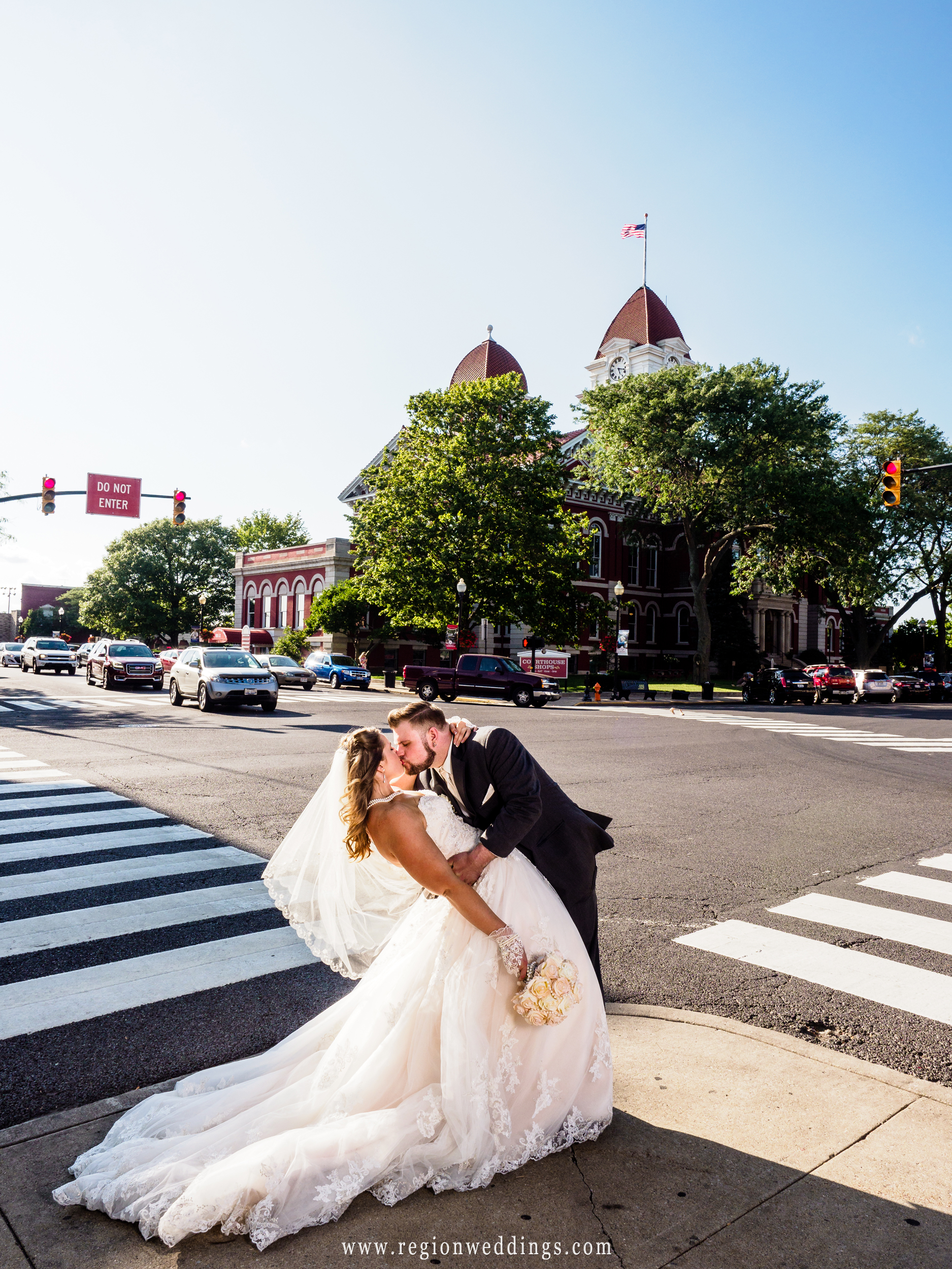 The groom dips his bride in downtown Crown Point, Indiana.