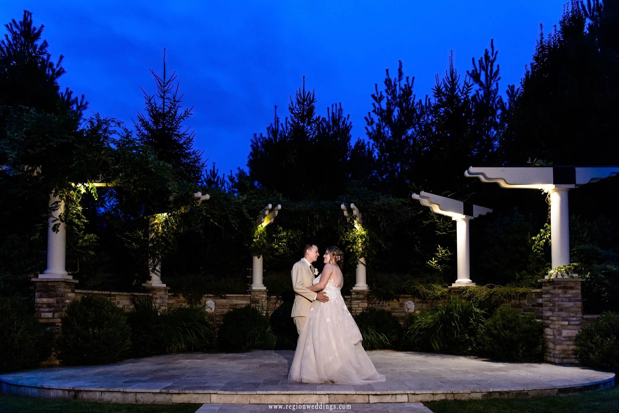 The bride and groom dance underneath the stars at their summer wedding.