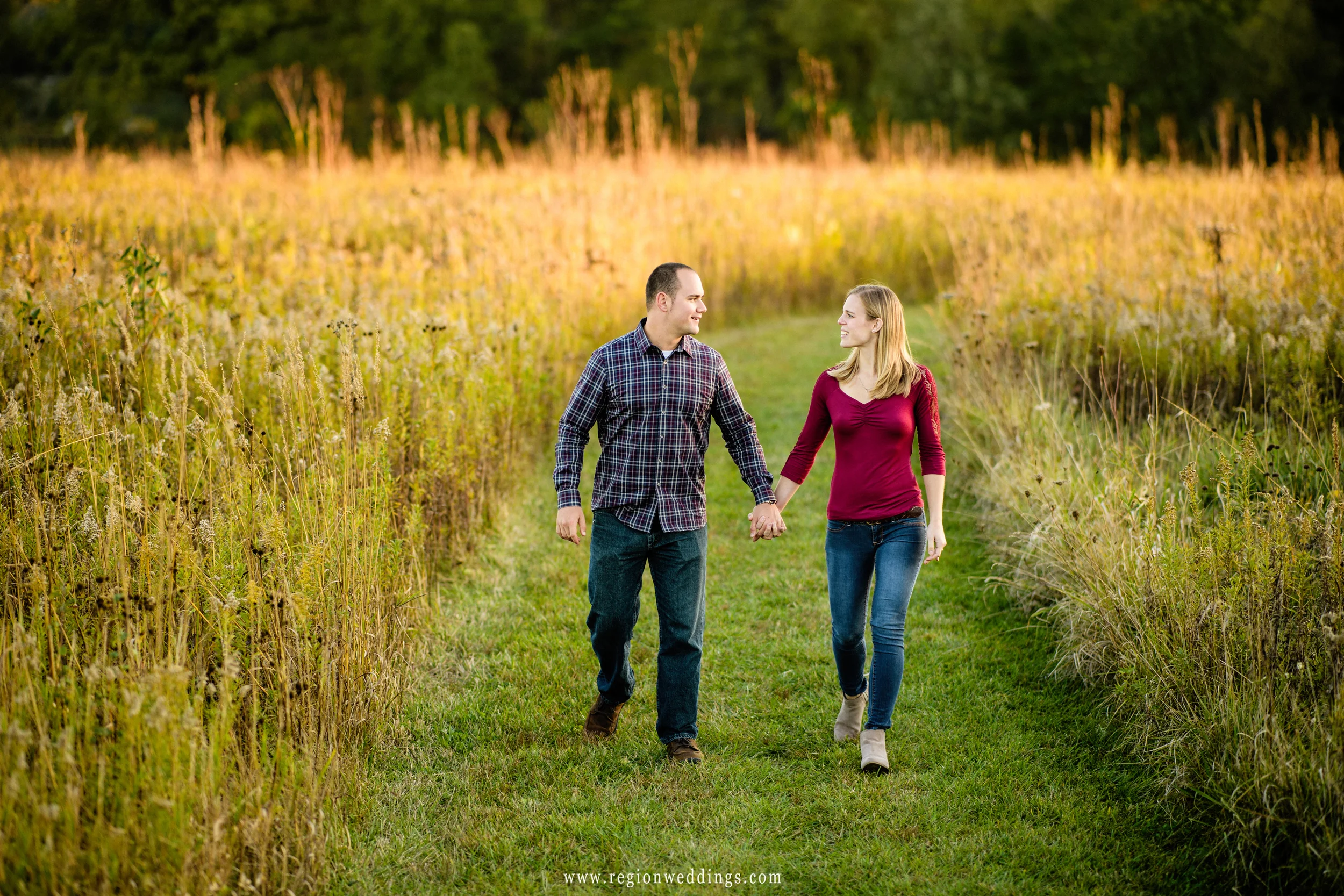 The sun sets upon the widlflowers as a couple in loves takes a romantic stroll.