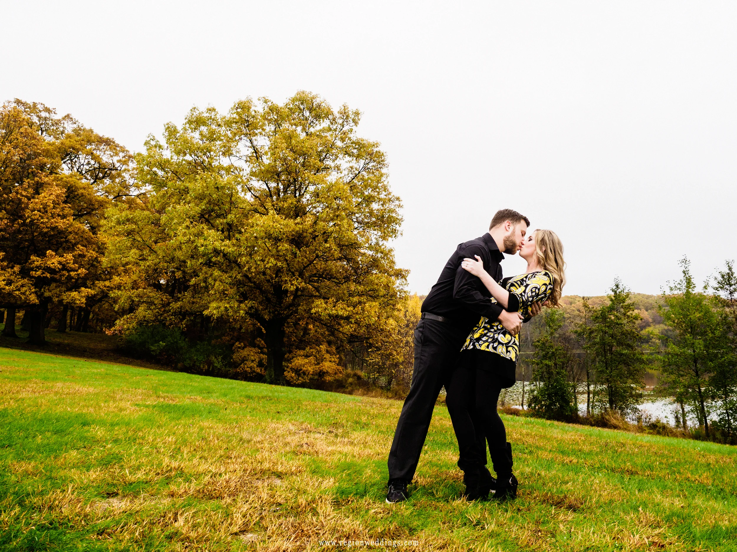 Romantic dip on a hill during a Fall engagement session.