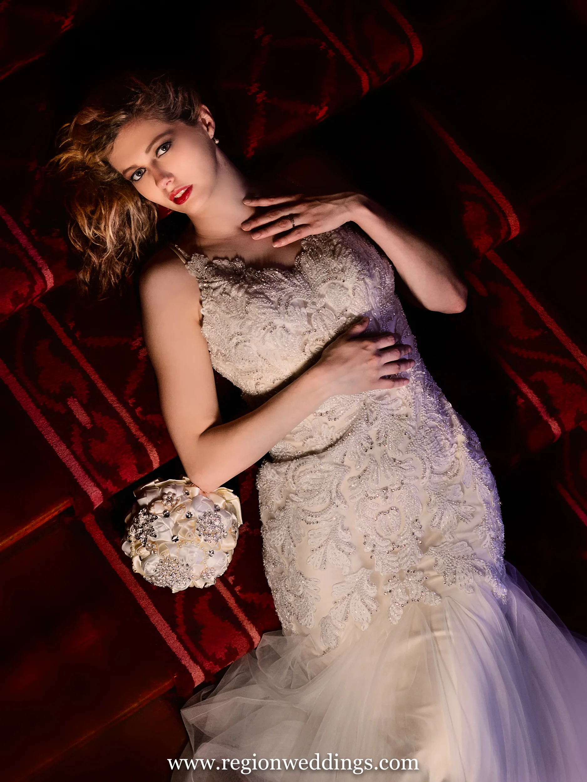 Bride on red staircase at Barker Mansion in Michigan City, IN.