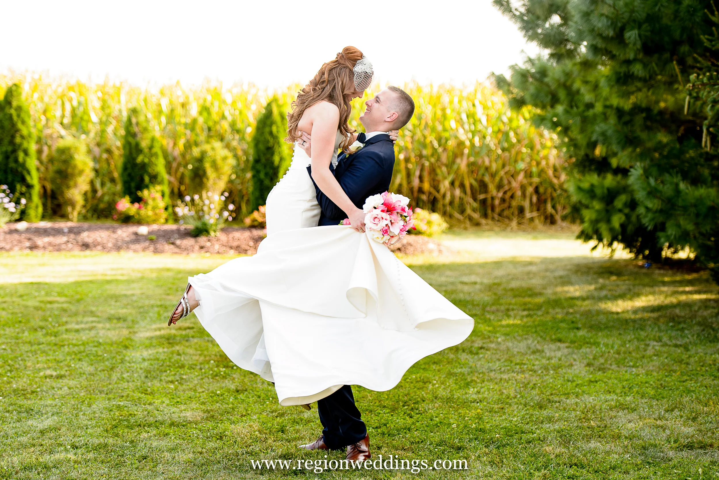 The groom spins his bride near the cornfields of Indiana.