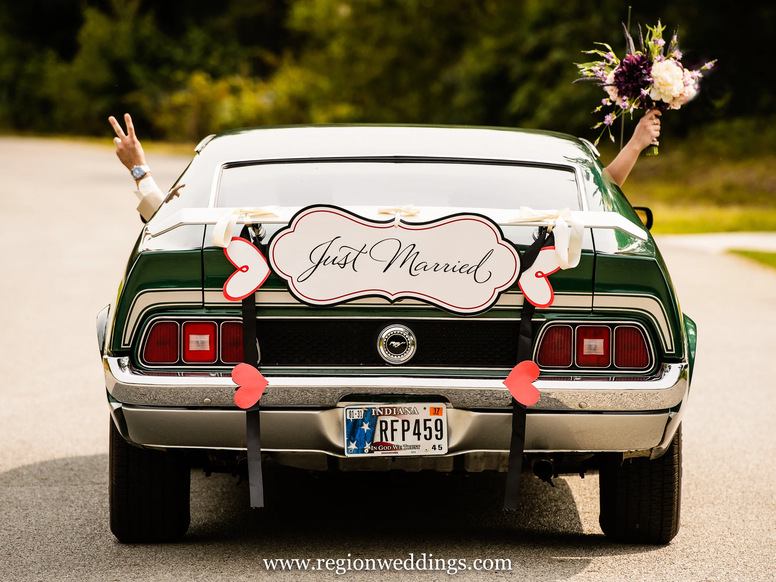Bride and groom ride away in a classic Mustang.