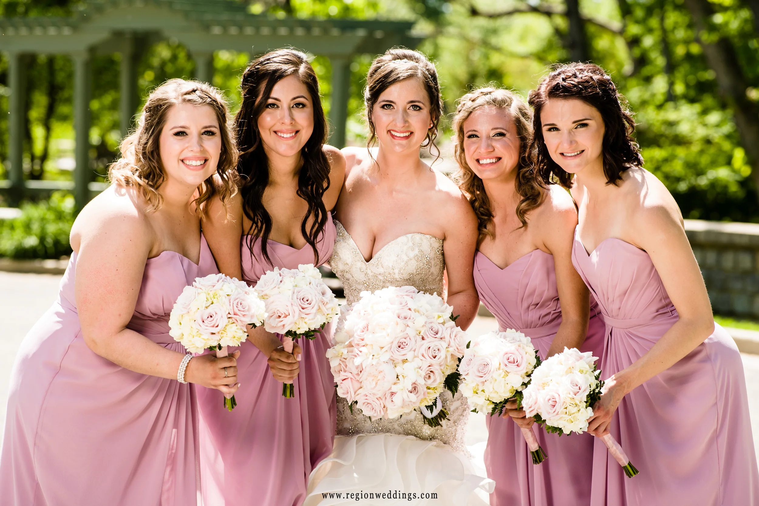 The bridesmaids huddle up with the bride at a Valparaiso wedding.