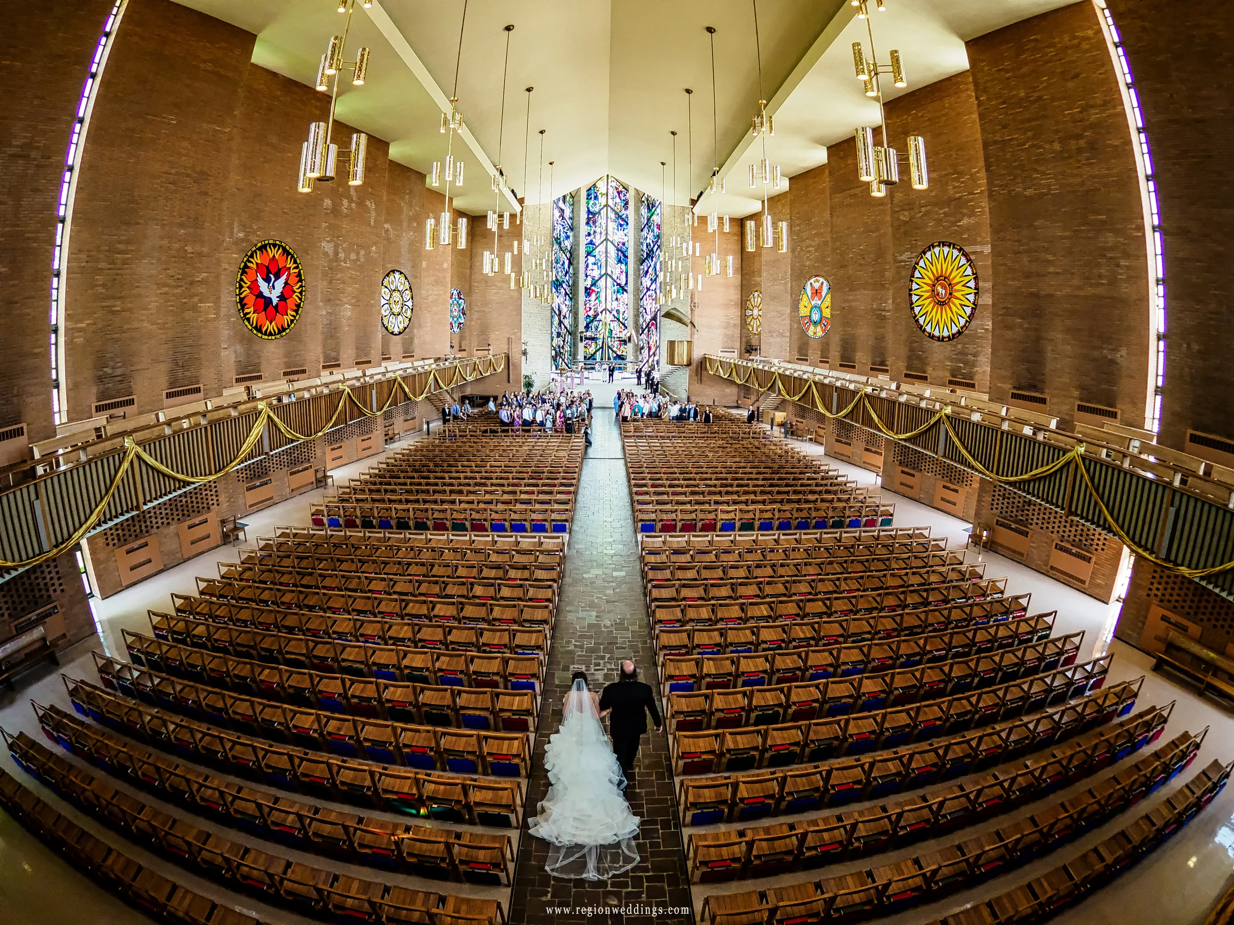 Father of the bride walks with his daughter at Chapel of the Resurrection.