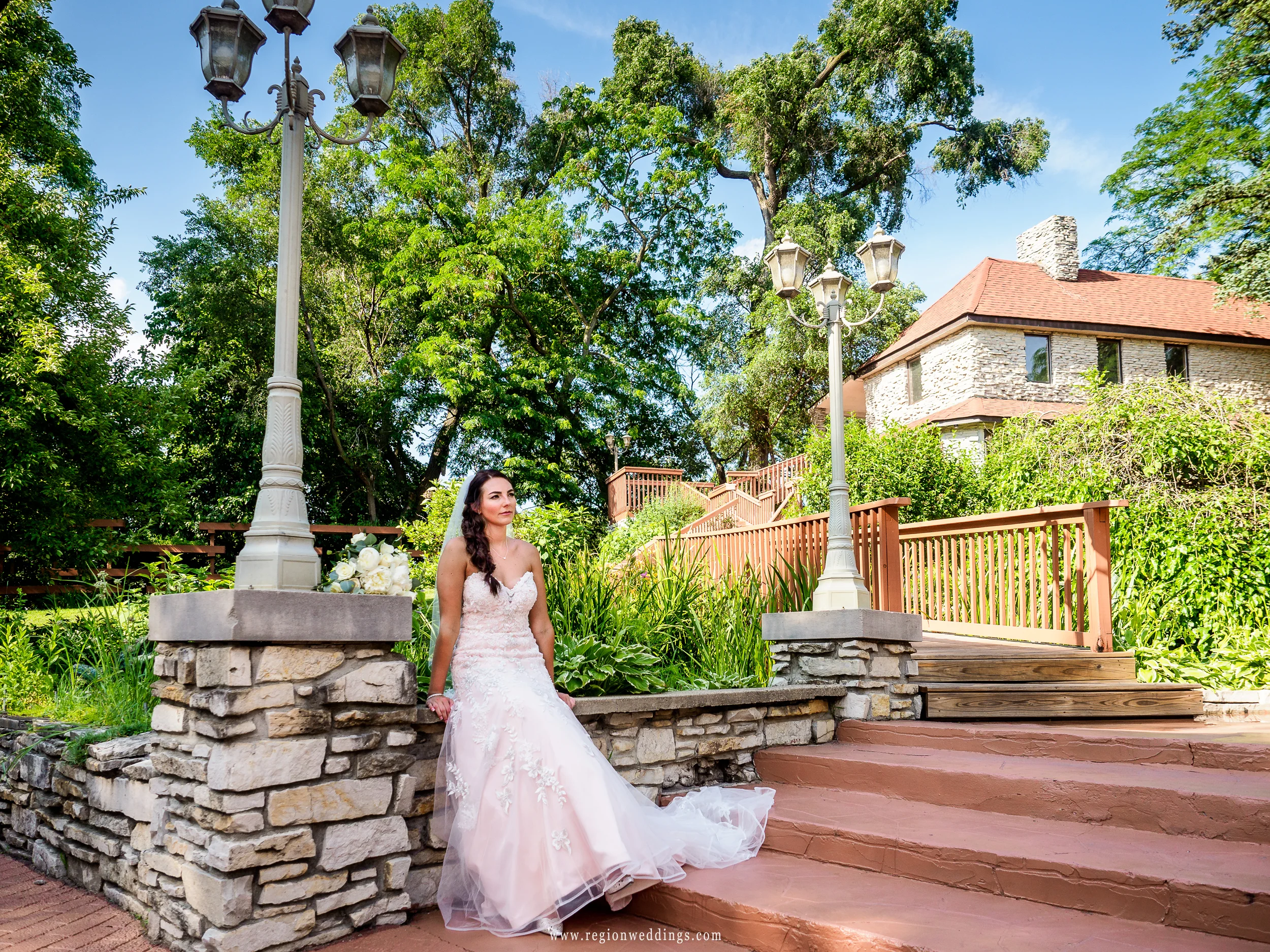 The bride takes a break on the castle steps.