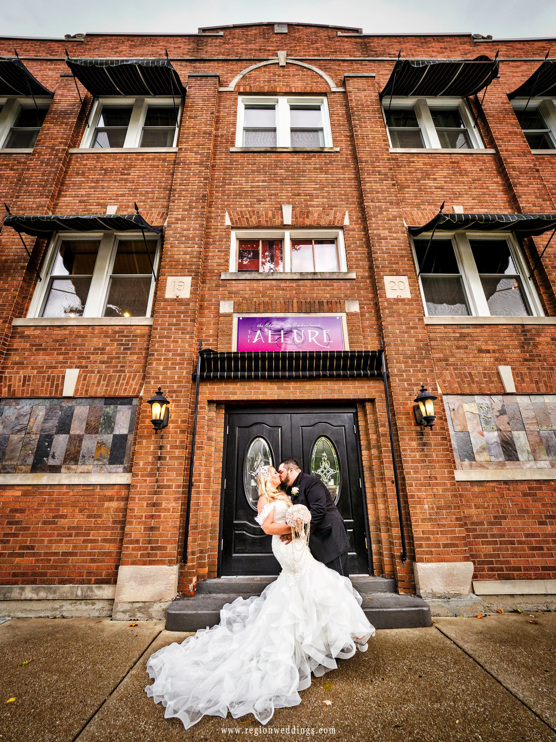 The groom dips his bride in front of The Allure wedding venue in Laporte, Indiana.