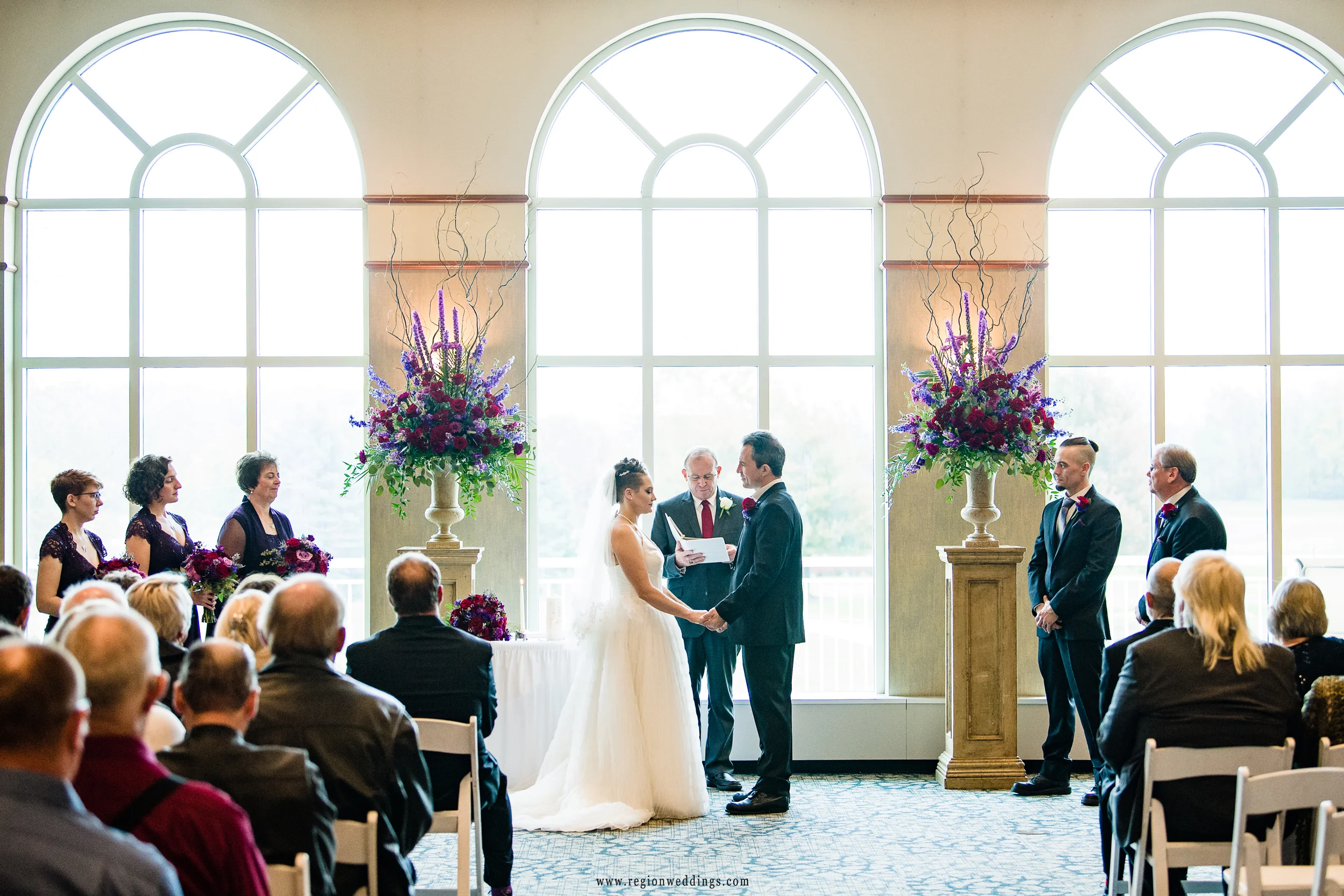 Bride and groom exchange vows at Sand Creek Country Club.