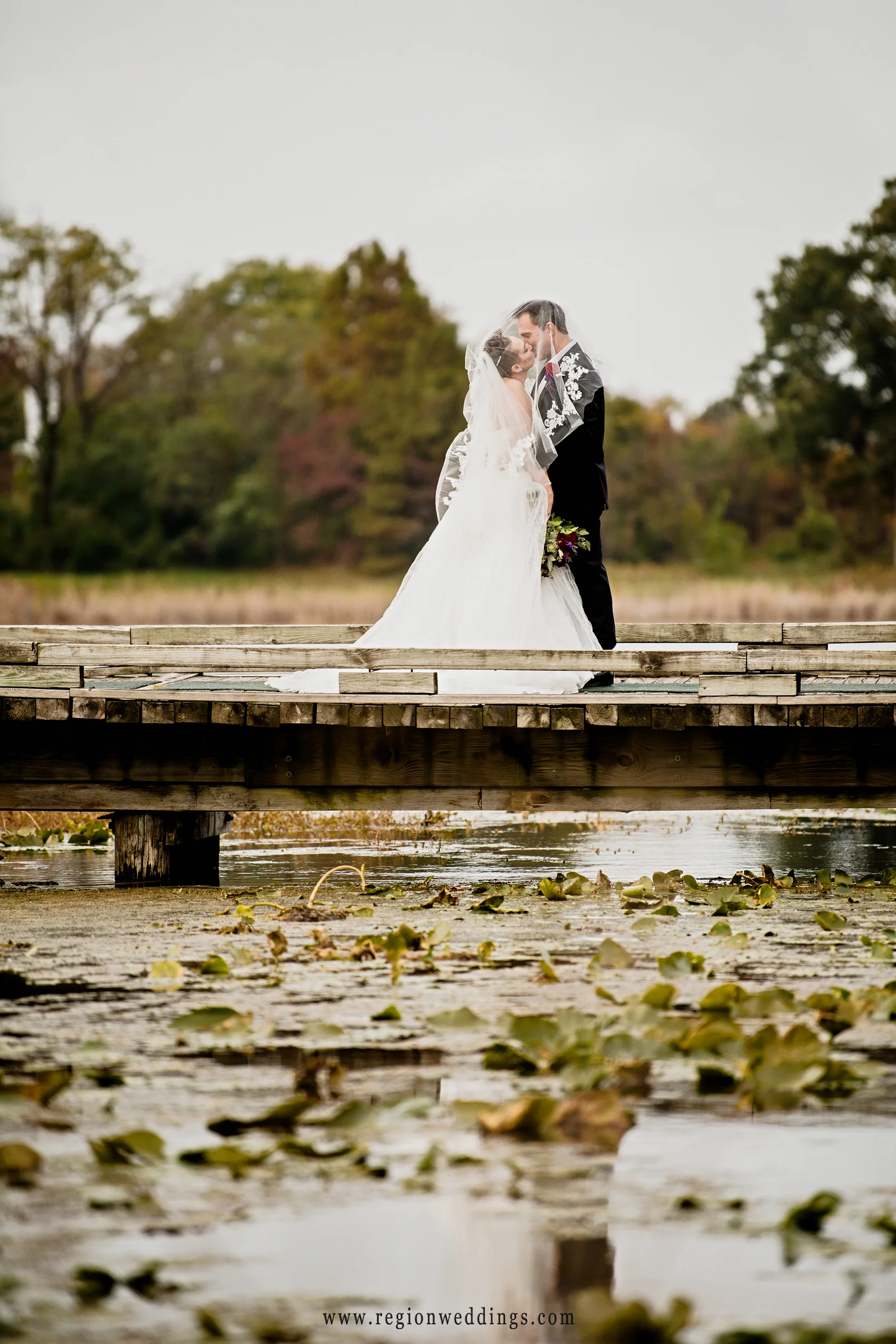 Under the veil kiss at Sand Creek Country Club in Chesterton, Indiana.