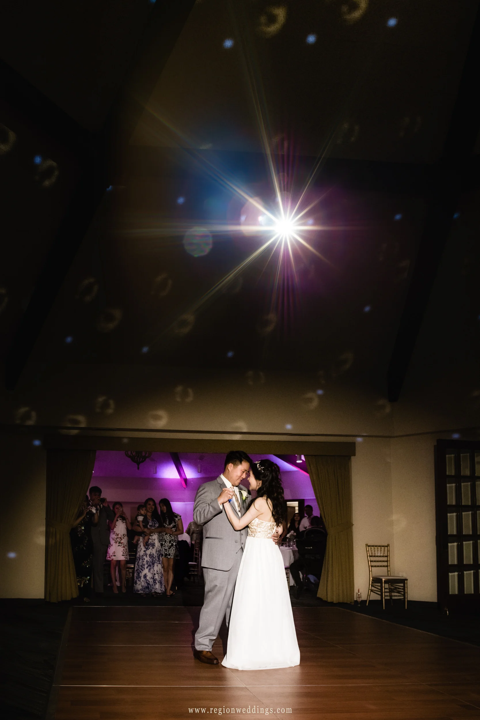 First dance for the bride and groom as romantic lighting engulfs the dance floor.