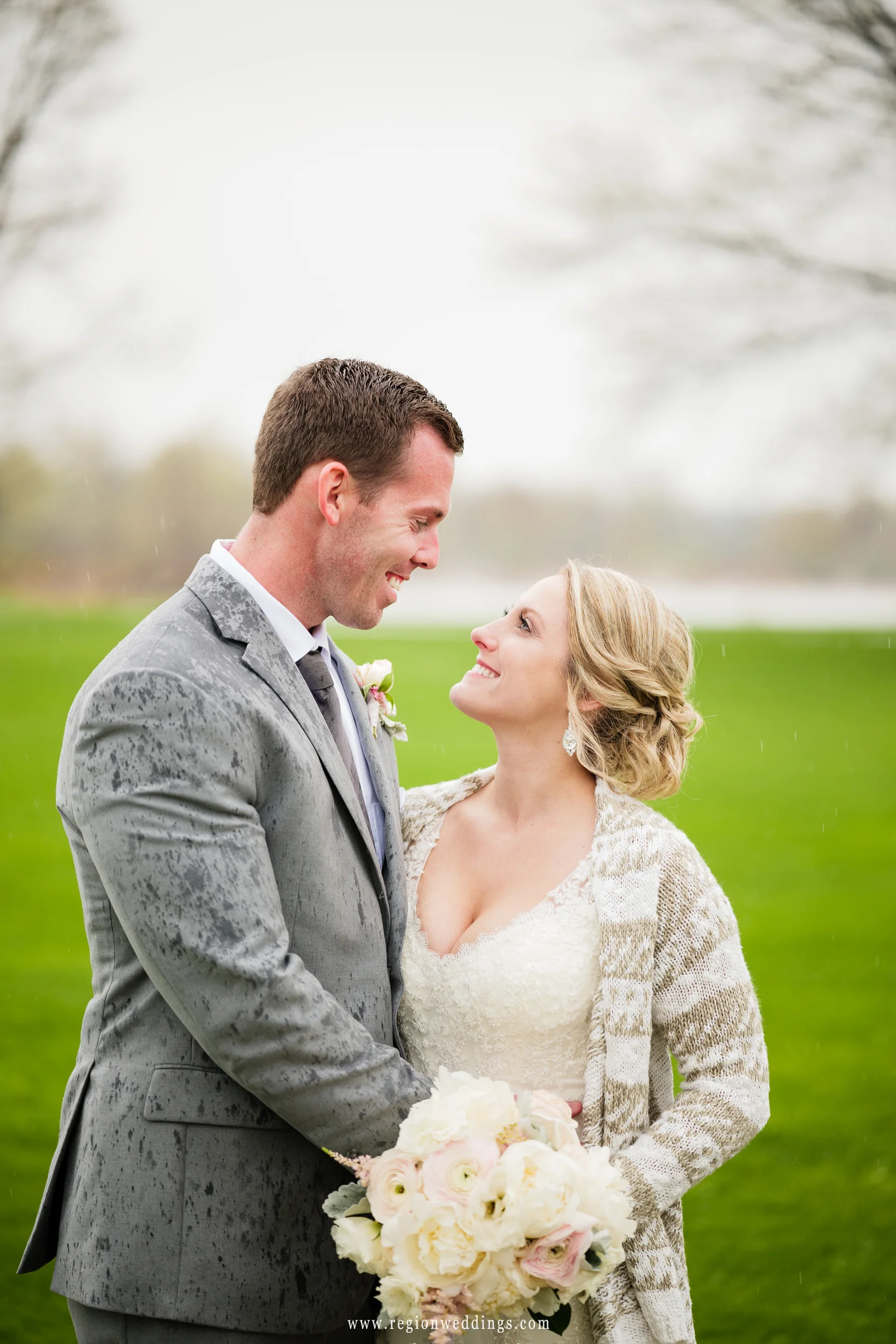 A tender moment in the rain with the bride and groom.