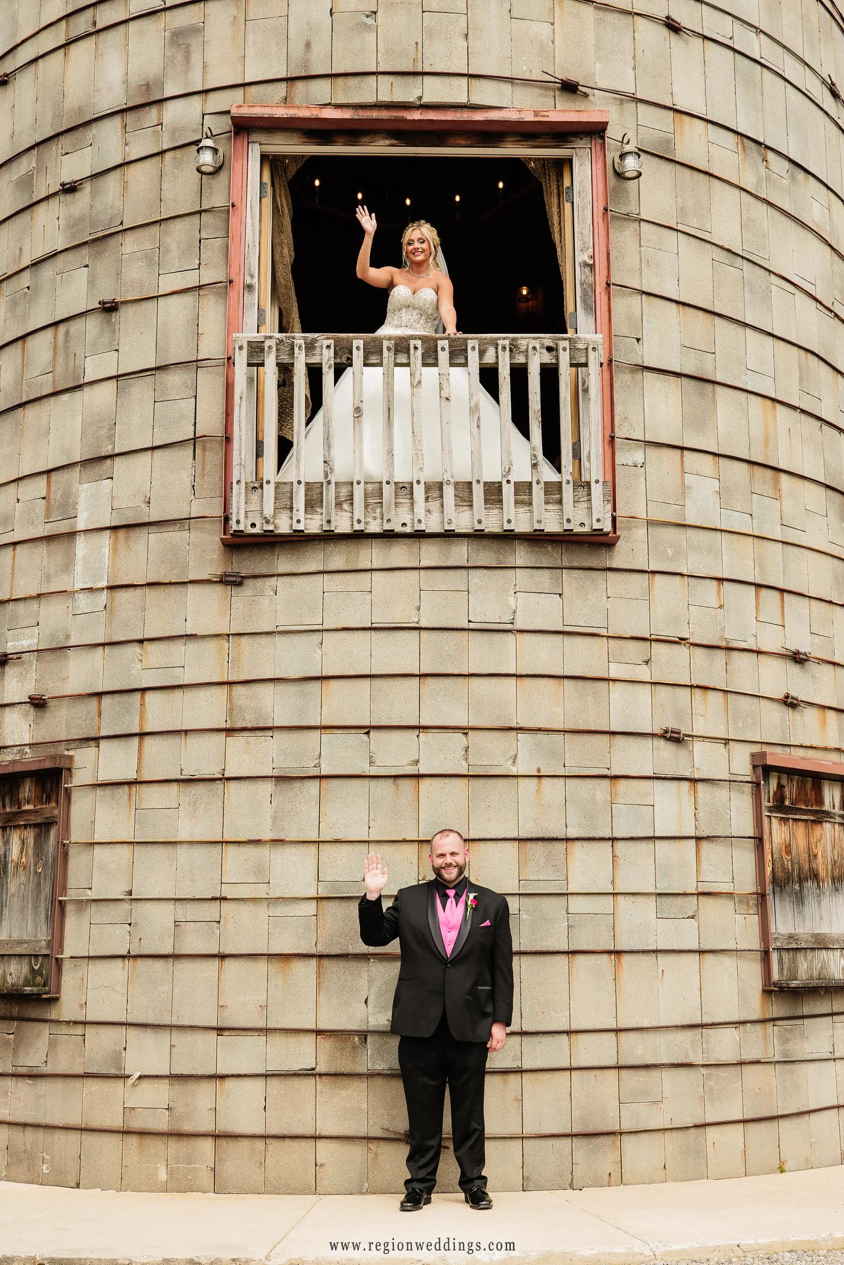 Bride and groom wave outside the grain silo at County Line Orchard.