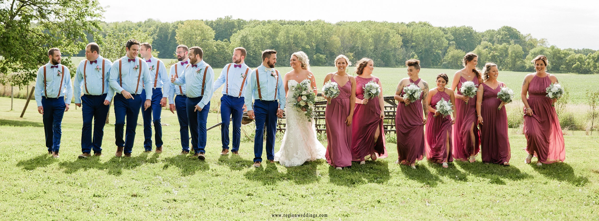The wedding party takes a walk through the fields at Four Corners Winery.